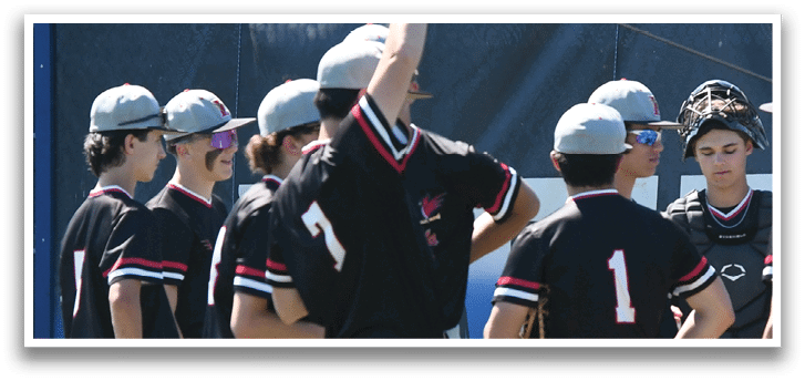A group of baseball players sitting on the grass. Description generated by AI