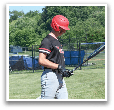 A baseball player in a red shirt and white pants is swinging a bat. Description generated by AI