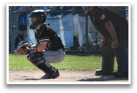 A baseball player in a red shirt is pitching a ball. Description generated by AI