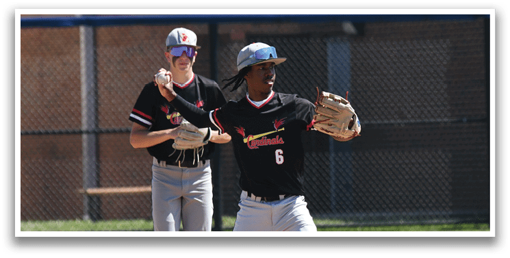 A group of young men wearing red and white baseball uniforms. Description generated by AI