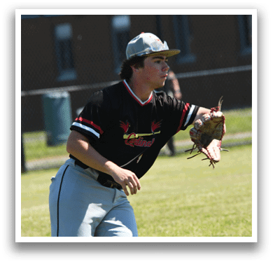A baseball player wearing a red and white uniform holding a baseball glove. Description generated by AI