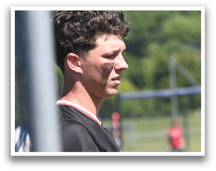 A baseball player is holding a bat and getting ready to hit the ball. Description generated by AI