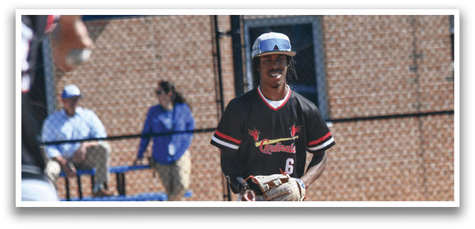 A baseball player in a red shirt and white pants is holding a baseball glove. Description generated by AI