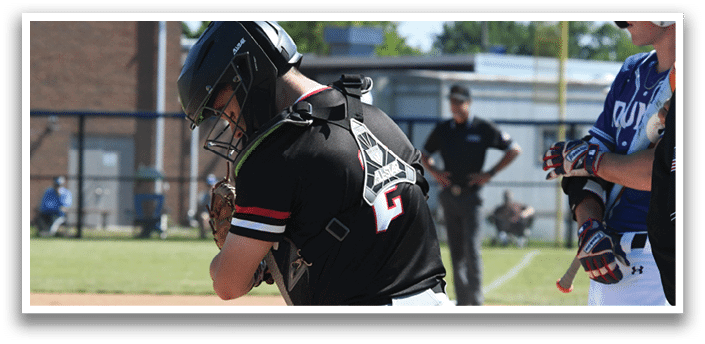 A baseball player in a red shirt and white pants is holding a baseball glove. Description generated by AI