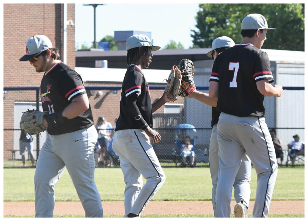 A baseball player in a black and white uniform is swinging a bat. Description generated by AI