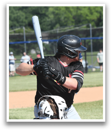 A baseball player holding a bat. Description generated by AI