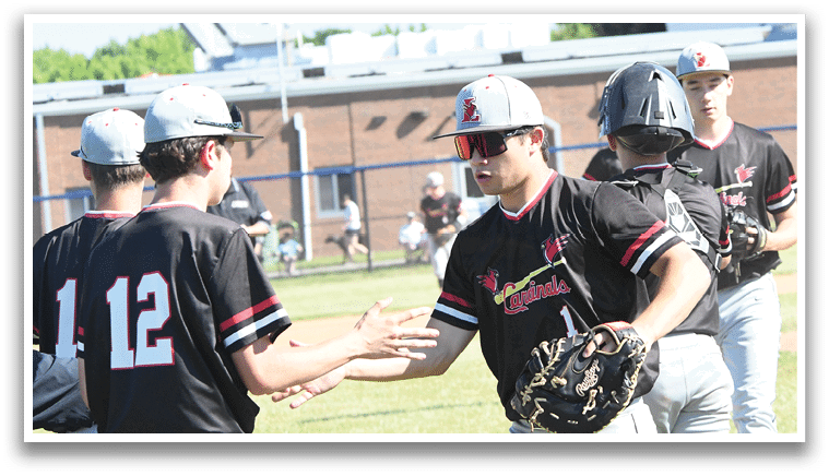 A group of baseball players wearing red and white uniforms. Description generated by AI