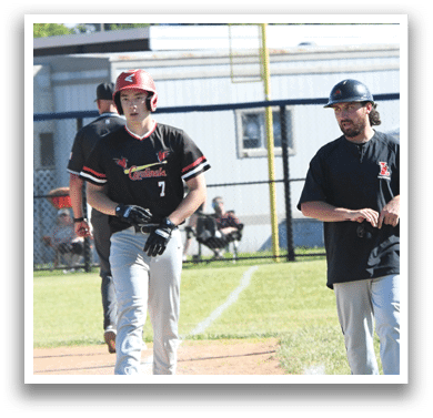 A baseball player wearing a red shirt and black helmet. Description generated by AI