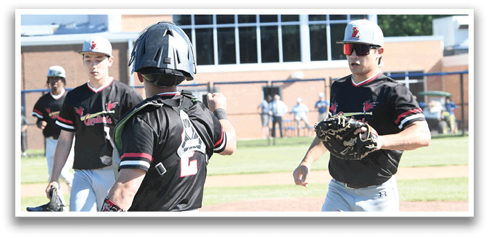 A group of baseball players wearing red and white uniforms. Description generated by AI
