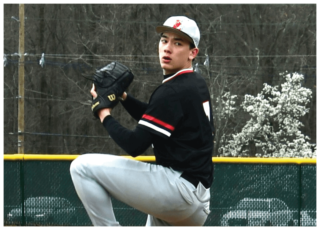 A baseball player in a black shirt and red shoes is pitching a ball. Description generated by AI