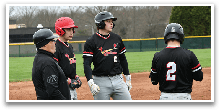Baseball players wearing black shirts and red hats. Description generated by AI