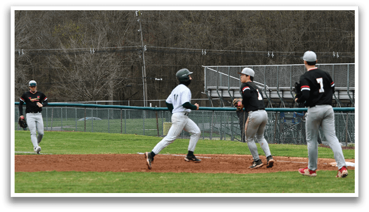 A baseball game is in progress with a player running to a base. Description generated by AI