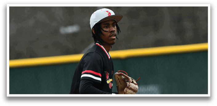 A baseball player wearing a black shirt and white pants is standing on a baseball field. Description generated by AI