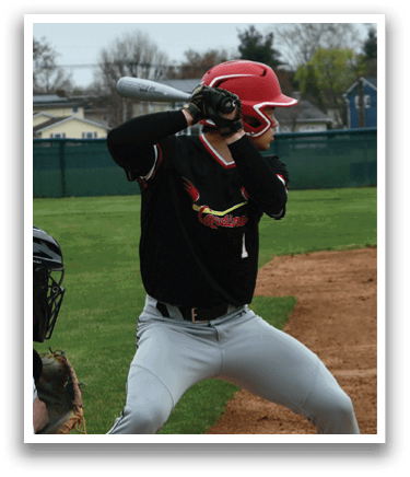 A baseball player in a black and red jersey is swinging a bat. Description generated by AI