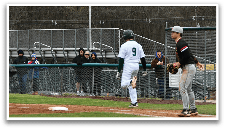 A baseball game is taking place with a player holding a bat and another player holding a baseball glove. Description generated by AI