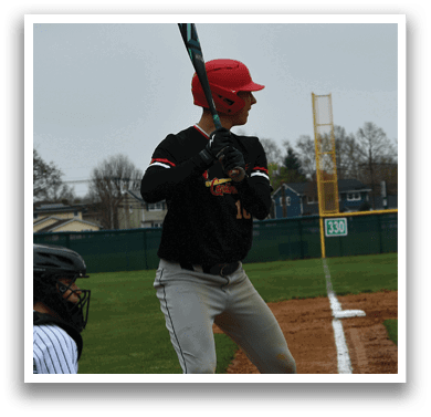 A baseball player in a black and red uniform is holding a bat and getting ready to hit a ball. Description generated by AI