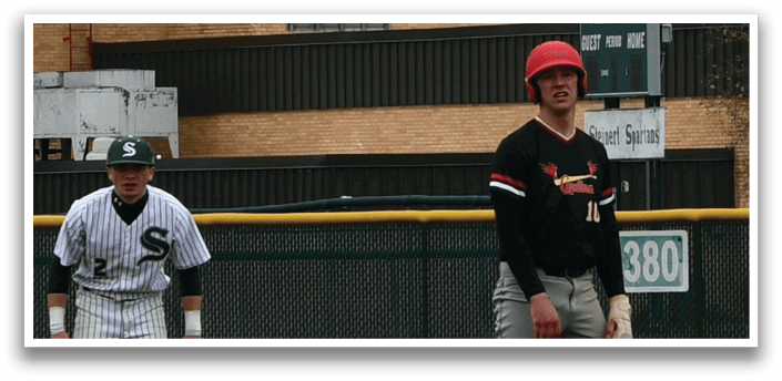 A baseball player wearing a red helmet and black shirt. Description generated by AI