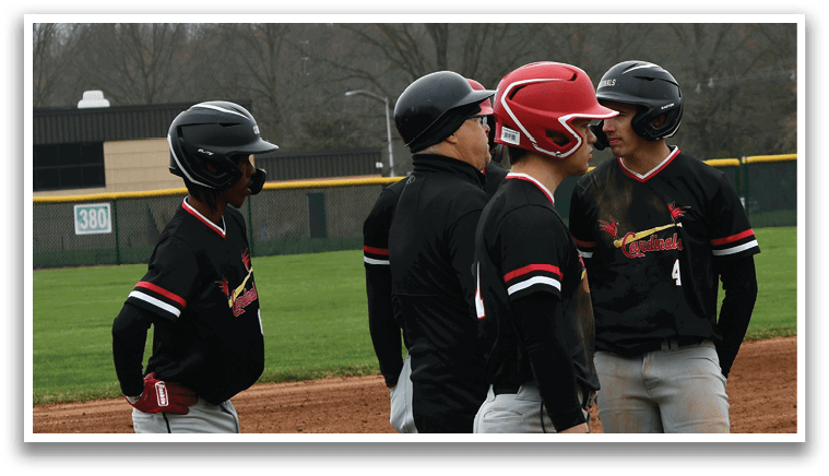 Baseball players standing on a field. Description generated by AI