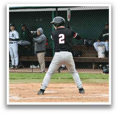 A baseball player is at bat, wearing a black shirt and holding a bat. Description generated by AI