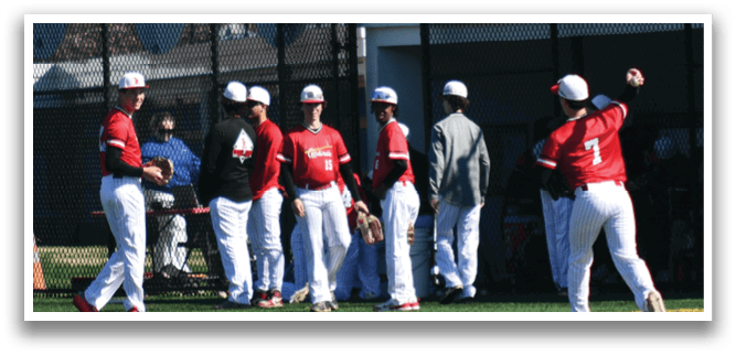 A group of baseball players standing on a field. Description generated by AI