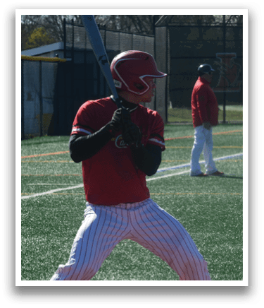 A baseball player in a red and white striped uniform holding a bat. Description generated by AI