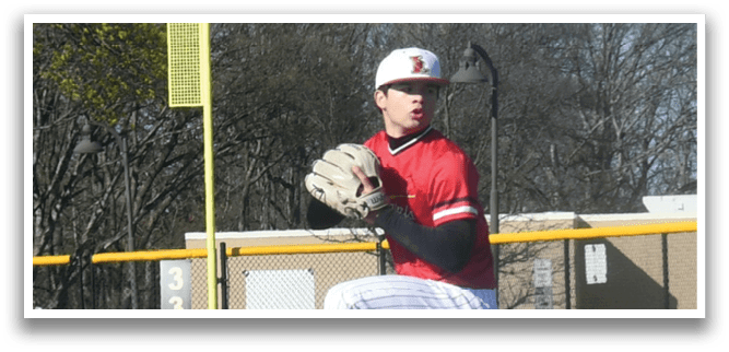 A baseball player in a red and white uniform is pitching a ball. Description generated by AI