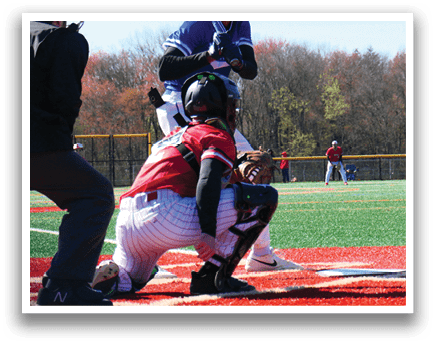 A baseball player wearing a red jersey is kneeling on the ground. Description generated by AI