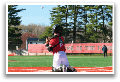 A baseball player is squatting down on the field. Description generated by AI