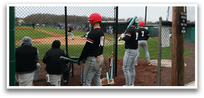 A baseball player holding a bat. Description generated by AI