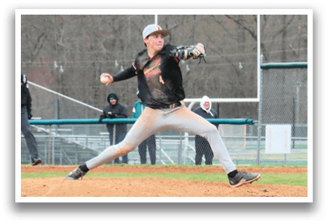 A baseball player in a black shirt and white pants is pitching a ball. Description generated by AI