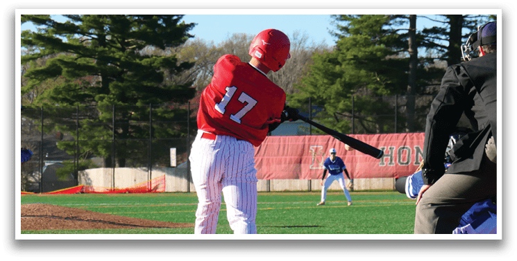 A baseball player is at bat, wearing a red shirt and white pants. Description generated by AI