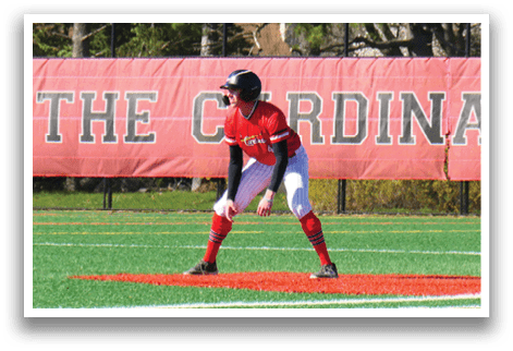 A baseball player is at bat, wearing a red shirt and white pants. Description generated by AI