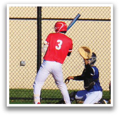 A baseball player is holding a bat and getting ready to hit a ball. Description generated by AI