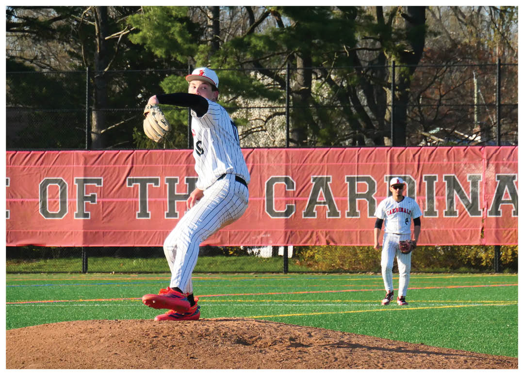 A baseball player in a black and white uniform is pitching a ball. Description generated by AI
