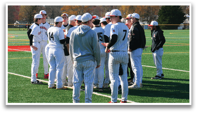 A group of baseball players wearing white and red uniforms. Description generated by AI