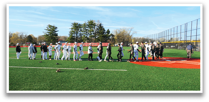 A group of people walking on a field. Description generated by AI