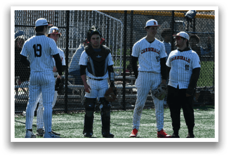 A group of baseball players standing on a field. Description generated by AI