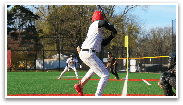 A baseball player in a white uniform is swinging a bat. Description generated by AI