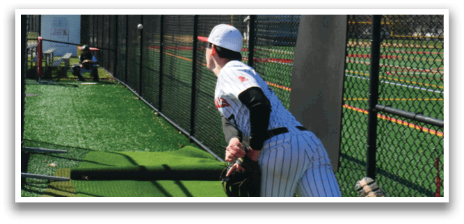 A baseball player in a black and white uniform is pitching a ball. Description generated by AI
