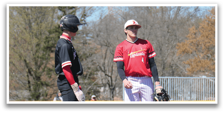 Two baseball players standing on a field. Description generated by AI