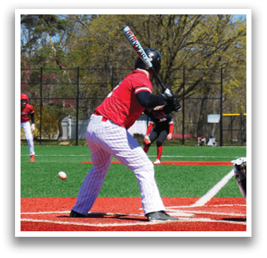 A baseball player is at bat, holding a bat and preparing to swing. Description generated by AI