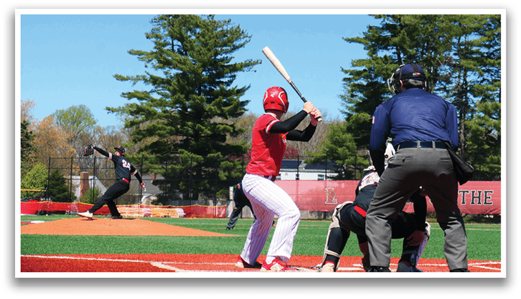 A baseball player holding a bat. Description generated by AI