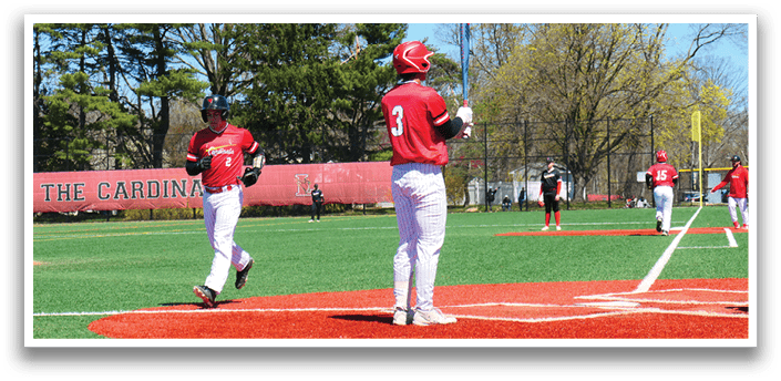 A baseball game is taking place on a field with players in red and white uniforms. Description generated by AI