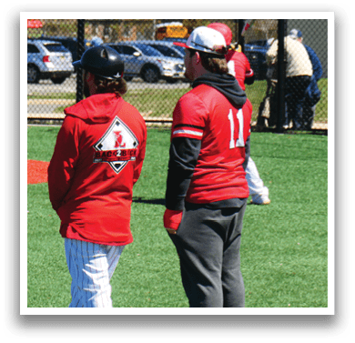 Two men wearing red and black jackets. Description generated by AI