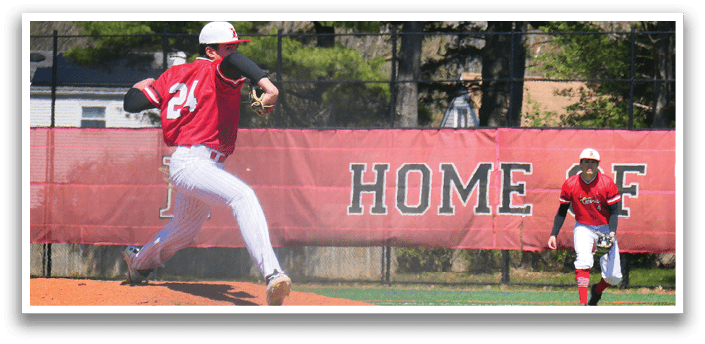A baseball player in a red shirt and white pants is pitching a ball. Description generated by AI