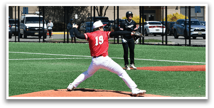 A baseball player in a red shirt and white pants is pitching a ball. Description generated by AI