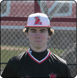 A man wearing a baseball uniform stands in front of a fence. AI generated content