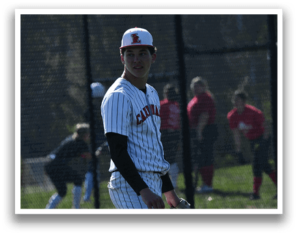 A baseball player wearing a white and red uniform. Description generated by AI