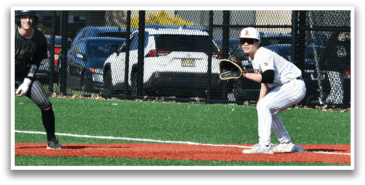 A baseball player is holding a baseball bat and standing next to a base. Description generated by AI