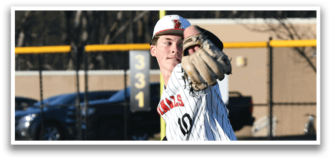 A baseball player in a black and white uniform is pitching a ball. Description generated by AI